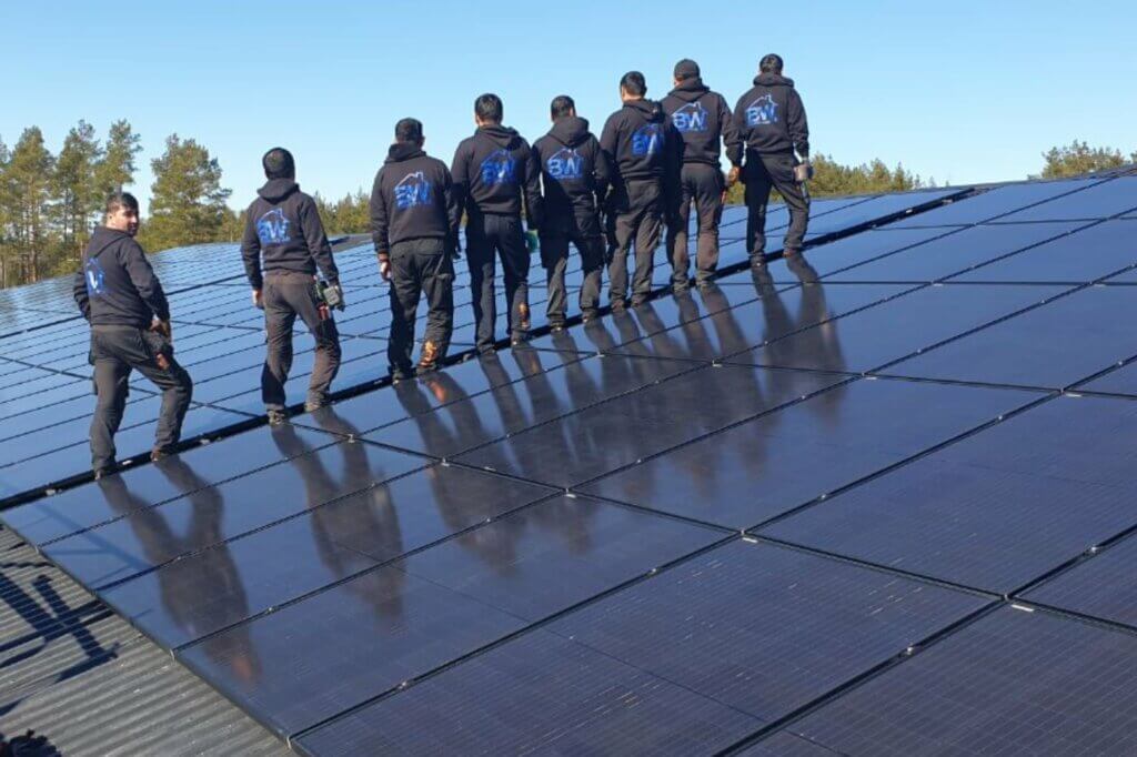 Solceller Stockholm montörer står på tak med solceller